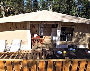 Enjoy the terrace of the Deluxe Lodge Tent in Cavriglia, Tuscany, overlooking the surrounding nature from this luxurious glamping lodge.