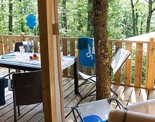 Interior of Lodge Tent Deluxe in Cavriglia, Tuscany, with modern kitchen and dining area, ideal for glamping.