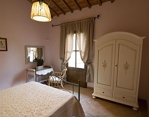 Attractive bedroom at Agriturismo Mara in Castelfiorentino, Tuscany, with rustic interior and views of nature.