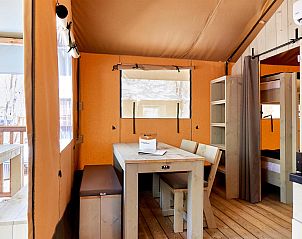 Cozy interior of Outback tent house in Cavallino, Veneto with wooden interior and dining table.