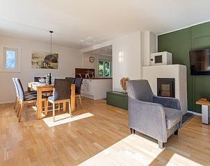 Modern kitchen in Villa Taube, vacation home in Bad Gastein, Salzburg overlooking the green surroundings.