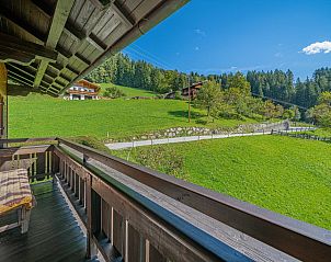 Cozy bedroom in Haus Leitner, vacation home in Westendorf, Tyrol, with wooden furniture and views of nature.