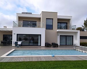 Villa da Figueira, a modern vacation home with pool in Nadadouro, Vale do Tejo, Portugal, surrounded by lush nature.