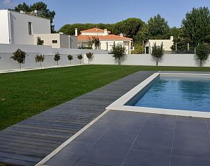 Enjoy the serene garden and pool at Villa da Figueira, a beautiful vacation home in Nadadouro, Vale do Tejo, Portugal.