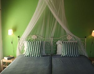 Attractive bedroom in Verdemar vacation home, Cercal do Alentejo, Portugal, with green walls and comfortable beds.