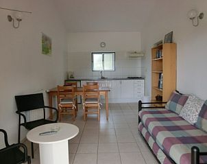 Spacious living room in Portucampo apartment, V.N. de Poiares, Alentejo, Portugal, with comfortable sitting area and dining area.