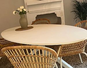 Gezellige eetkamer in Casa Lucy, vakantiehuis in lora, Andalusi, met rustieke stoelen en decoratieve open haard.