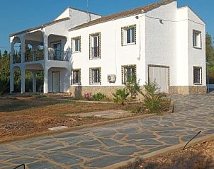 Finca Kim vakantiehuis in Lliria, Valencia, bij nacht verlicht met een uitnodigende veranda en omgeven door natuur.