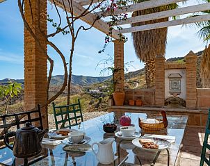 Enjoy the terrace of Holiday Home in Puerto las Tinajuelas, El Borge, with panoramic views of the hills of Costa del Sol, Spain.