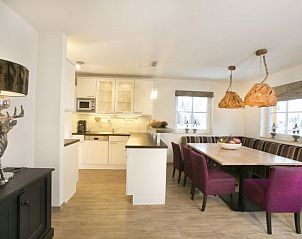 Gezellige eetruimte in Stunning Alpin Apartment, Lenk im Simmental, Berner Oberland, met moderne keuken en sfeervolle verlichting.