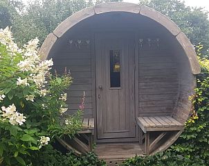Rustikale Holzsauna inmitten von Blumen im Ferienhaus in Dieverbrug, Drenthe.