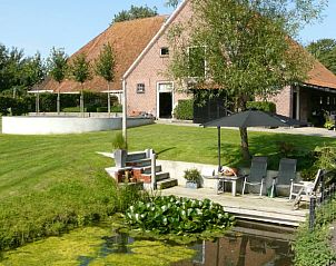 Zonnig terras aan het water bij Huisje in Bolsward, vakantiehuis in de Friese elfsteden, voor ontspanning.
