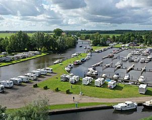 Terras met uitzicht op boten bij vakantiehuis FR094, De Westereen