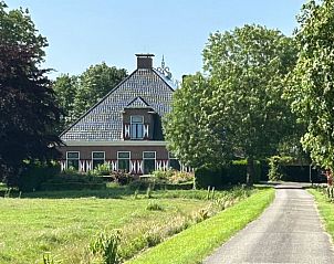 Traditional Frisian farmhouse near Holiday home in Haskerhorne, surrounded by greenery and rustic charm.