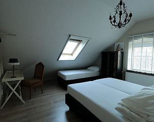 Sfeervolle slaapkamer in Vakantiehuis in Moergestel, Hart van Brabant, Noord Brabant, met dakraam en klassieke inrichting.