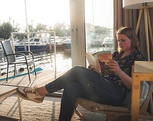 Lezen in de comfortabele woonkamer van Vakantiehuis in Dinteloord, West Brabant.