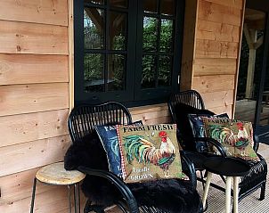 Comfortabele zitplek op de veranda van Vakantiehuisje in Oudenbosch, West Brabant, perfect voor ontspanning.