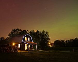 Discover the serene night atmosphere at Holiday Home in Schellinkhout, North Holland, with a beautifully lit sky above the vacation rental.