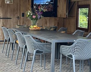 Overdekt terras bij Scholtefleer vakantiehuis in De Lutte, Twente met grote eettafel.