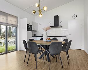 Decked dining table in Sallandse Heuvelrug 8C vacation home, Hoge Hexel, ready for a cozy meal.