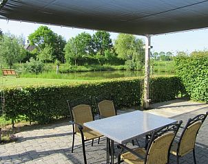 Shaded terrace overlooking the countryside at Holiday home in Olst, Salland, Overijssel.