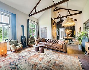 Stylish living room in Holiday Home in Diepenveen, with comfortable seating area and views of the green surroundings.