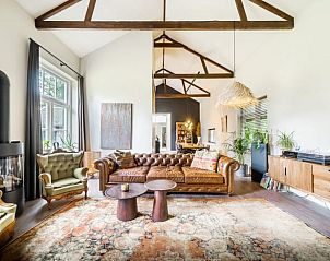 Spacious living room in Holiday Home in Diepenveen, with high ceilings and a beautiful view of the garden.