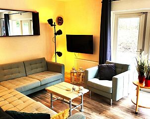 Gezellige woonkamer van De Duunhaes in Ouddorp, Zeeland met comfortabele zitbanken en moderne inrichting.