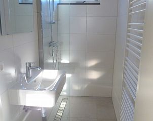Strakke badkamer met douche in Van de Zeeuwse Stromen vakantiehuis, Dishoek, Walcheren, Zeeland.