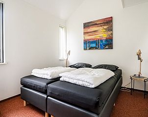 Gezellige slaapkamer in Westduin 4 Vlissingen, met kunst aan de muur en comfortabel bed, Walcheren, Zeeland.