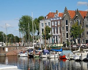 Pittoreske haven nabij Vakantiehuisje in Ritthem, Walcheren, Zeeland met historische gebouwen en boten.