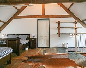 Spacious bedroom with wooden beams in vacation home Stolwijk, Alblasserwaard, South Holland.