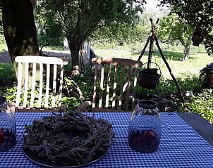 Rustic dining area in the garden of vacation home Stolwijk, Alblasserwaard, South Holland.