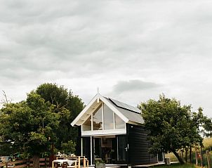 Buitenkant van Vakantiehuisje in Langerak, Zuid-Holland, omgeven door groen en rust.