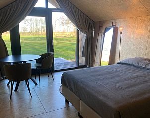 Cozy bedroom in Cottage in Sommeldsijk overlooking the green landscape of Sommelsdijk, Goeree-Overflakkee.