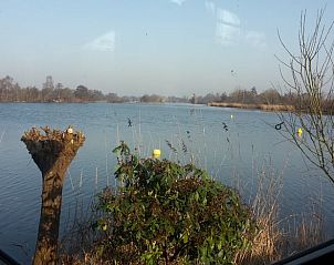Uitzicht op het meer vanuit de eetkamer van Vakantiehuis in Reeuwijk, Zuid-Holland.